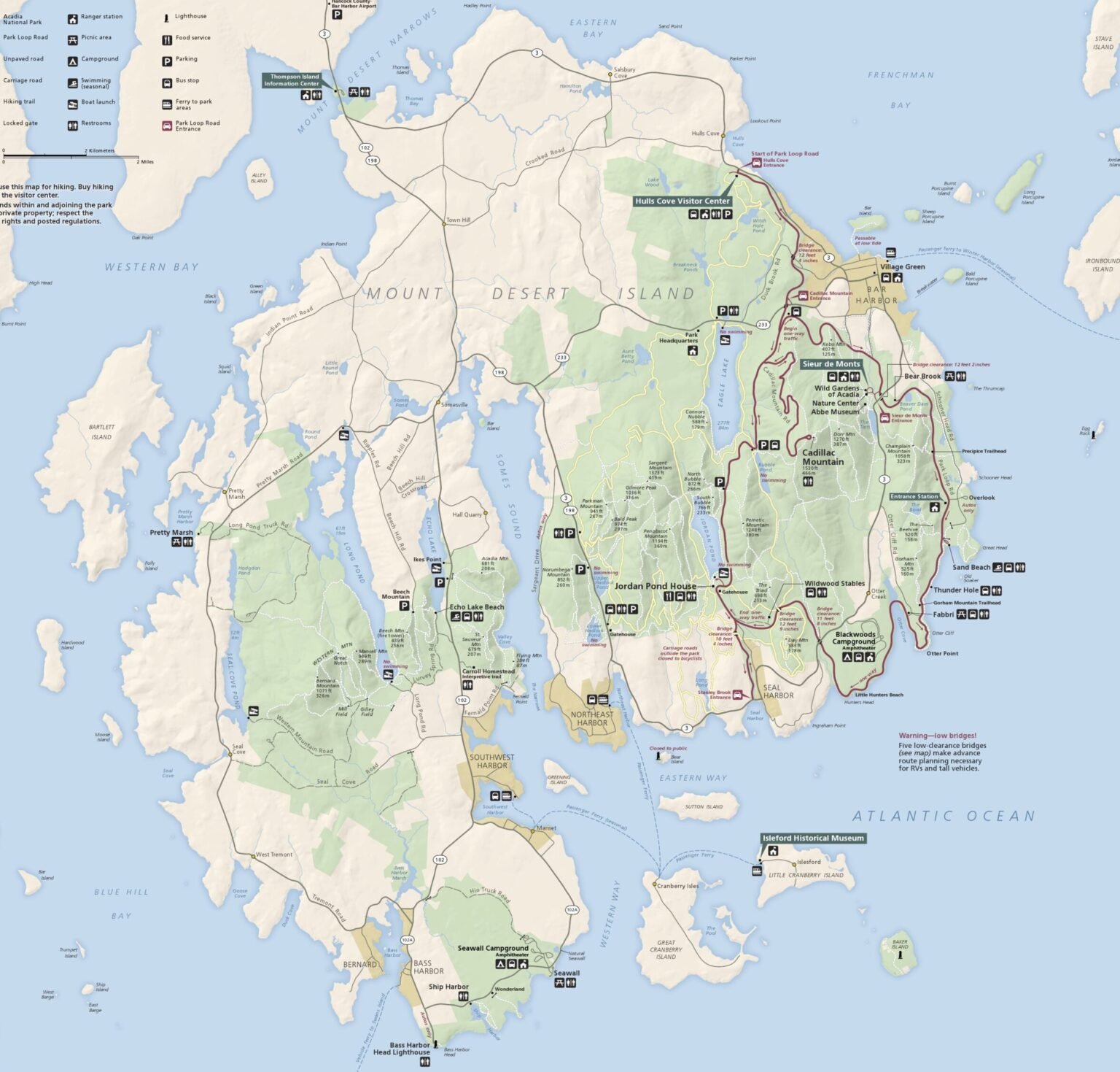 Map of Mount Desert Island, Maine, showing Acadia in a separate color which highlights the patchwork of land this park is. Acadia Driving Tours shows all of Park Loop Road in red on this map, as well as many more locations.