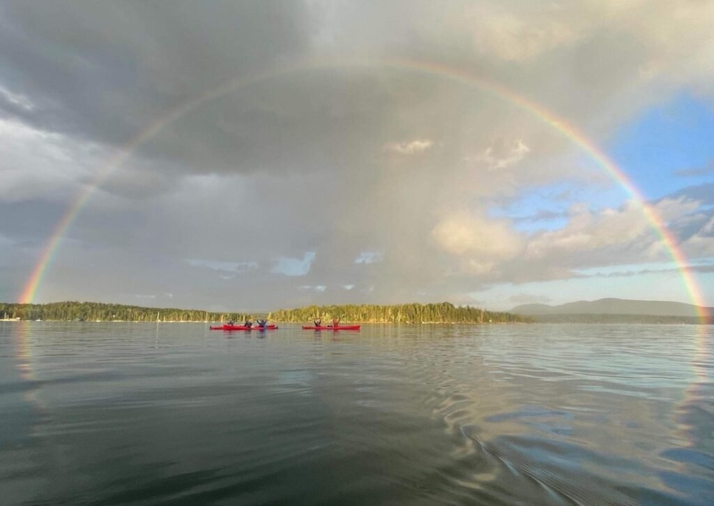 Rainbow over kayakers by Mount Desert Island quiet side